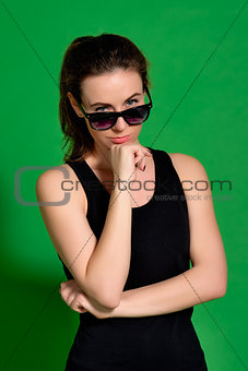 Young woman looking over sunglasses