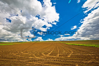 Plowed field under dramatic sky view