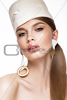 Pretty fresh girl, image of modern Twiggy in fashionable white hat, with unusual eyelashes and accessories.