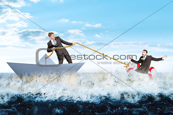 Businessman in paperboat save scared man