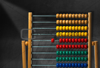Colorful Wooden Abacus on a Blackboard