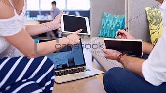 Headless crop of woman with tablet and man holding notebook