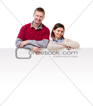 smiling couple lean on empty blanket for ad