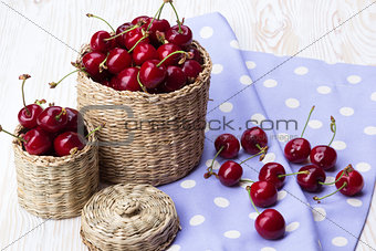 Cherry baskets on wooden background