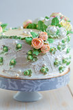 Cake with cream roses and sugar pearls.