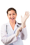 cheerful woman doctor puts on a rubber glove