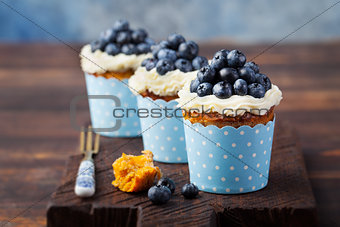 Pumpkin cupcakes with cream cheese, blueberries