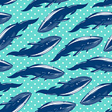 Seamless pattern with whales on blue dotted background