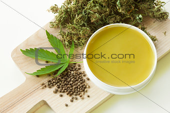 Cannabis healing ointment and marijuana leaf and seeds