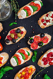 Bruschettas with tomatoes, herbs and olives