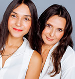 cute pretty teen daughter with mature mother hugging, fashion style brunette makeup