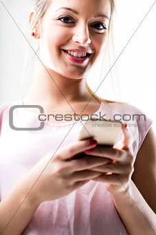 portrait of a woman texting with her mobile