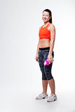 smiling gym dressed woman with her bottle