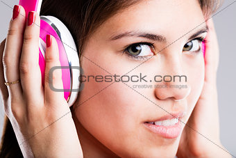 pink headphones and beautiful eyes of a woman