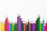 Color pencils arrangement on white
