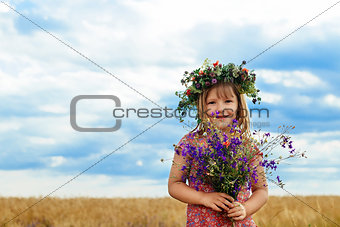 Cute little girl in summer wheat field