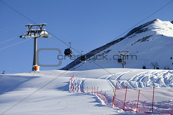 Gondola lift on ski resort at sun day