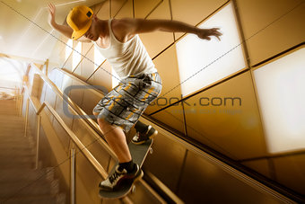 young skateboarder sliding down handrail