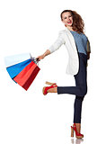 Smiling woman with shopping bags posing on white background