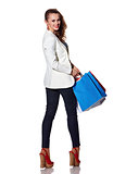 Happy woman with shopping bags on white background looking back