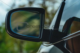 reflection in black elite car mirror