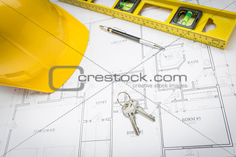 Hard Hat, Pencil, Level and Keys Resting on House Plans