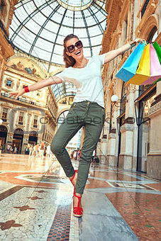Fashion monger with shopping bags having fun time in Galleria