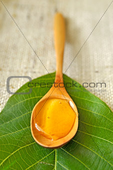 honey in a wooden spoon