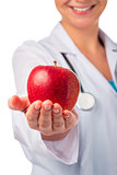red ripe apple in the palm of a smiling doctor
