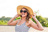 Portrait of elegant lady in hat on summer vacation