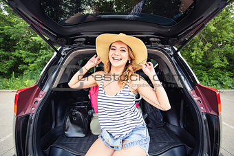 Vacation, Travel concept - young woman ready for the journey on summer holidays with suitcases and car