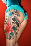 Tattooed womans leg and derriere