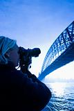 Male teen photographing bridge. 