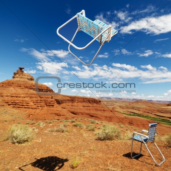 Lawn chairs in desert.