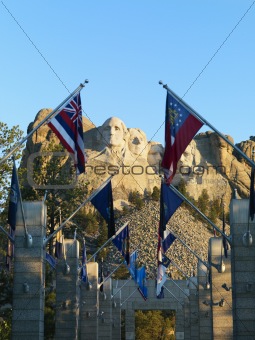 Mount Rushmore with flags.