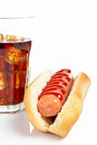 A hot dog and soda glass