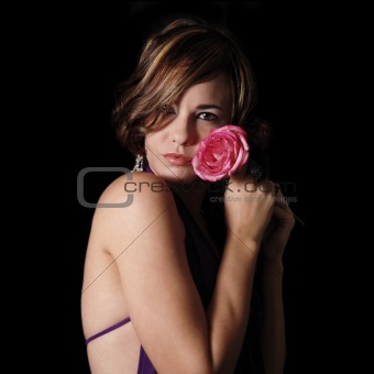 Young beauty holding a rose
