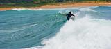 Surfer cuts back on big wave