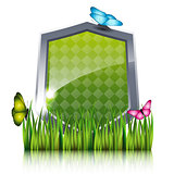 Green shield with flying butterflies by the grass.