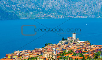 Top view to ancient tower and colorful houses in Malcesine old town