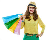 Smiling woman in hat with shopping bags on white background