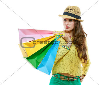 Woman with shopping bags on white background looking aside