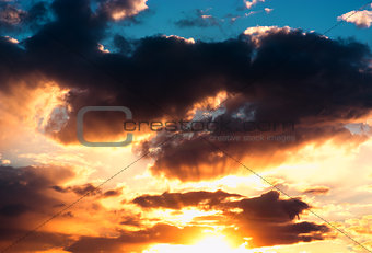 Dramatic sunset cloudscape with sun rays background