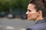 Profile portrait of pensive business woman at office district