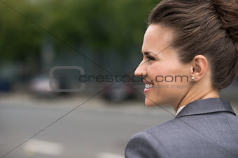Profile portrait of smiling business woman at office district