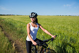 girl rides a bicycle in the countryside