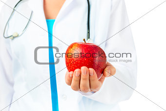 dentist holding a ripe apple good for the gums