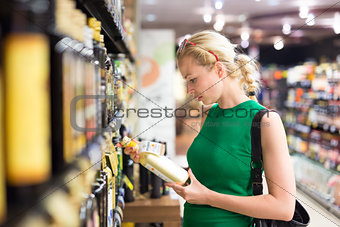Woman shopping groceries at supermarket.