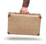 Male hand holding vintage suitcase