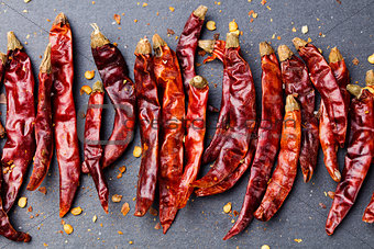 Dried red chili peppers on slate background Top view Copy space